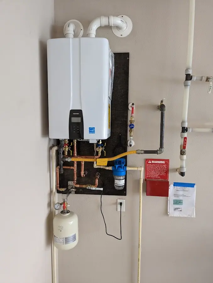 Professional plumber installing copper piping in a Holbrook home